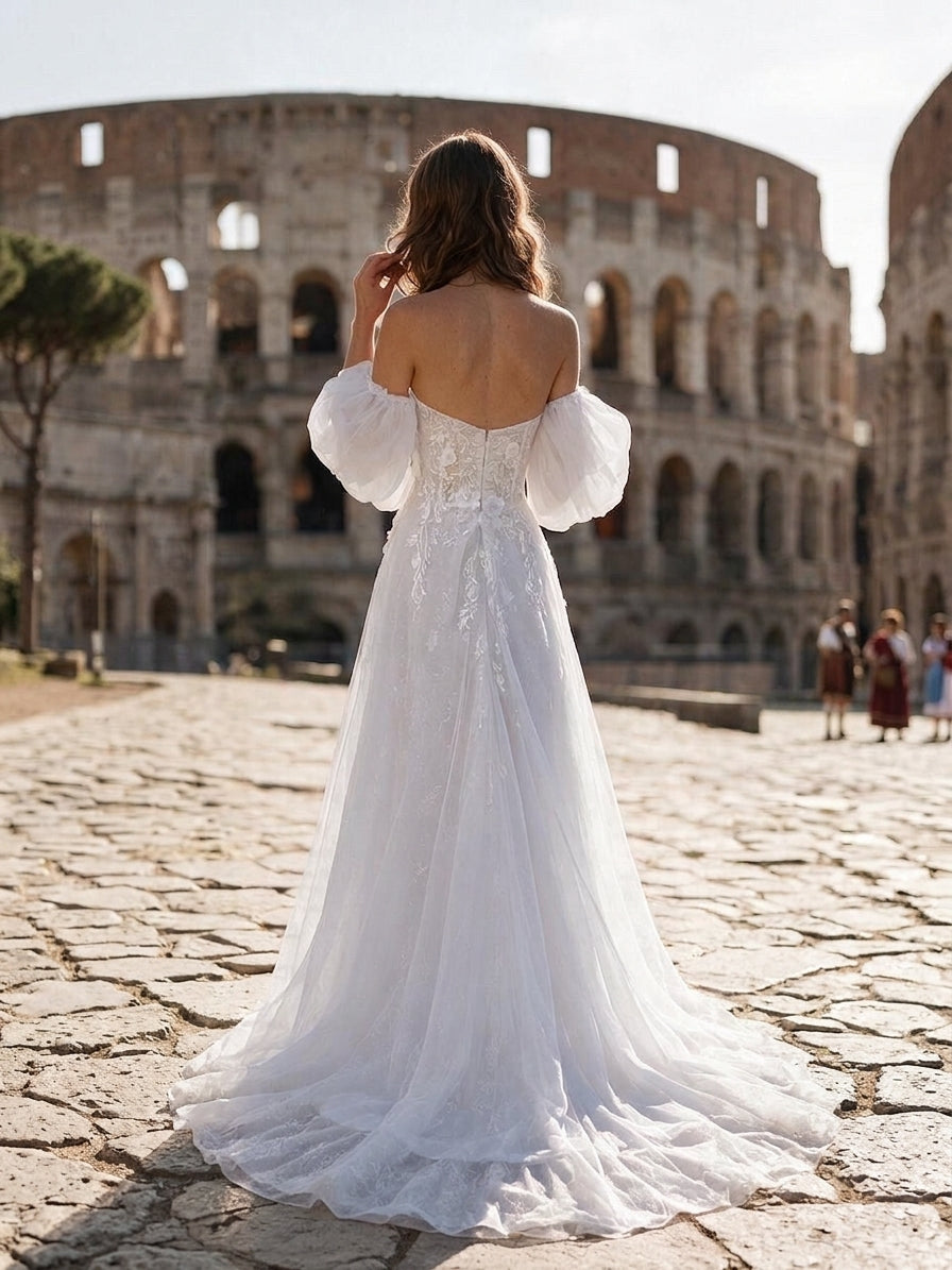 Lacey Bridal Ltd. Primrose A-line wedding gown with puff sleeves and 3D floral embroidery in front of the Colosseum.