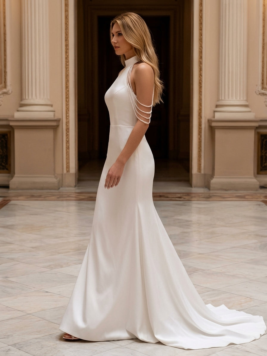 Lacey Bridal Ltd. Primula mermaid wedding gown in white stretch satin with a halter neck and pearl shoulder draping.