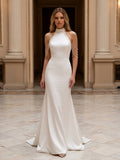 Lacey Bridal Ltd. PRIMULA mermaid wedding gown in white stretch satin with a halter neck and cascading pearl strands.