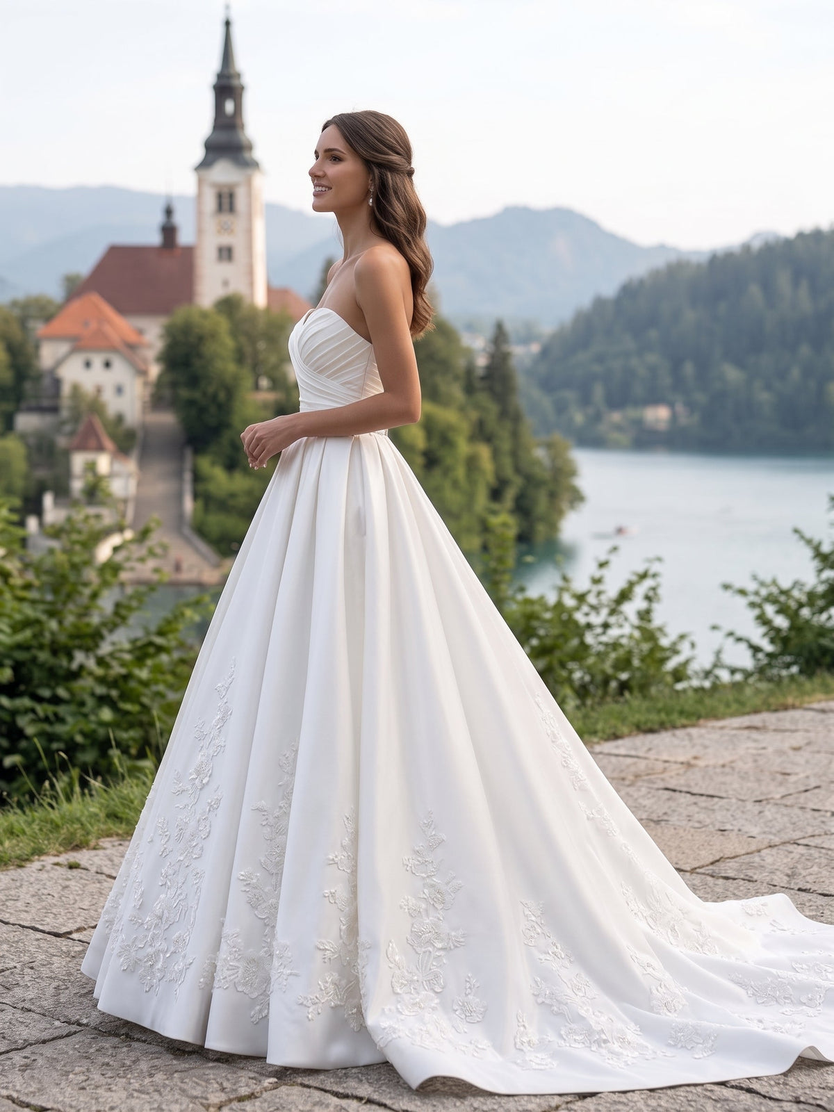 Lacey Bridal Ltd. Romilly satin ball gown with sweetheart neckline, ruched bodice, and floral lace hem at a lake.