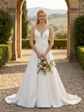 Lacey Bridal Ltd. Rosamund A-line satin wedding gown with spaghetti straps, V-neckline, and waist flower detail.