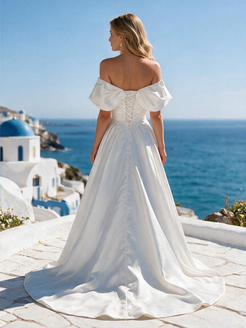 Lacey Bridal Ltd. Beatrice off-the-shoulder satin wedding gown with lace-up corset back and chapel-length train.