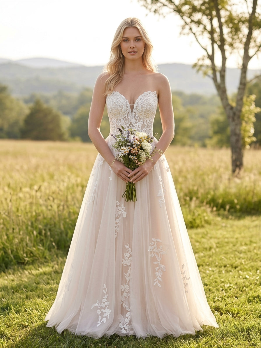 Lacey Bridal Ltd. Sibylla blush A-line wedding gown with floral lace bodice and tulle skirt in a meadow setting