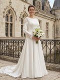 Lacey Bridal Ltd. Tatiana minimalist A-line wedding gown with long lace sleeves and boat neckline in a castle setting