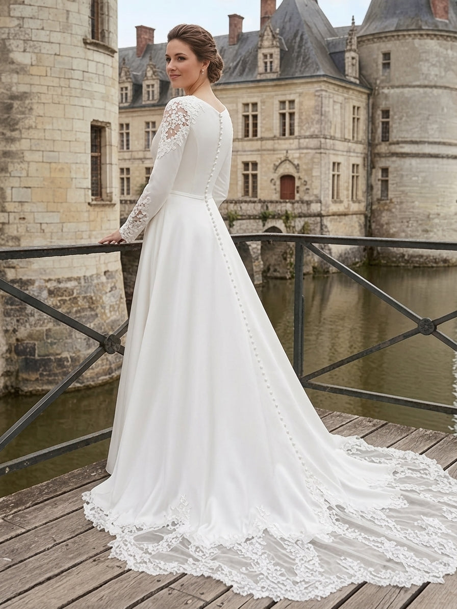 Lacey Bridal Ltd. Tatiana minimalist A-line wedding gown with long sleeves, lace details, and button-back train.