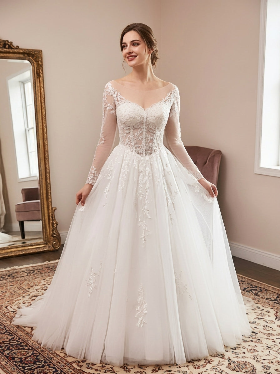 Lacey Bridal Ltd. Theodora wedding gown with illusion sleeves, embroidered corset bodice, and shimmering tulle skirt.