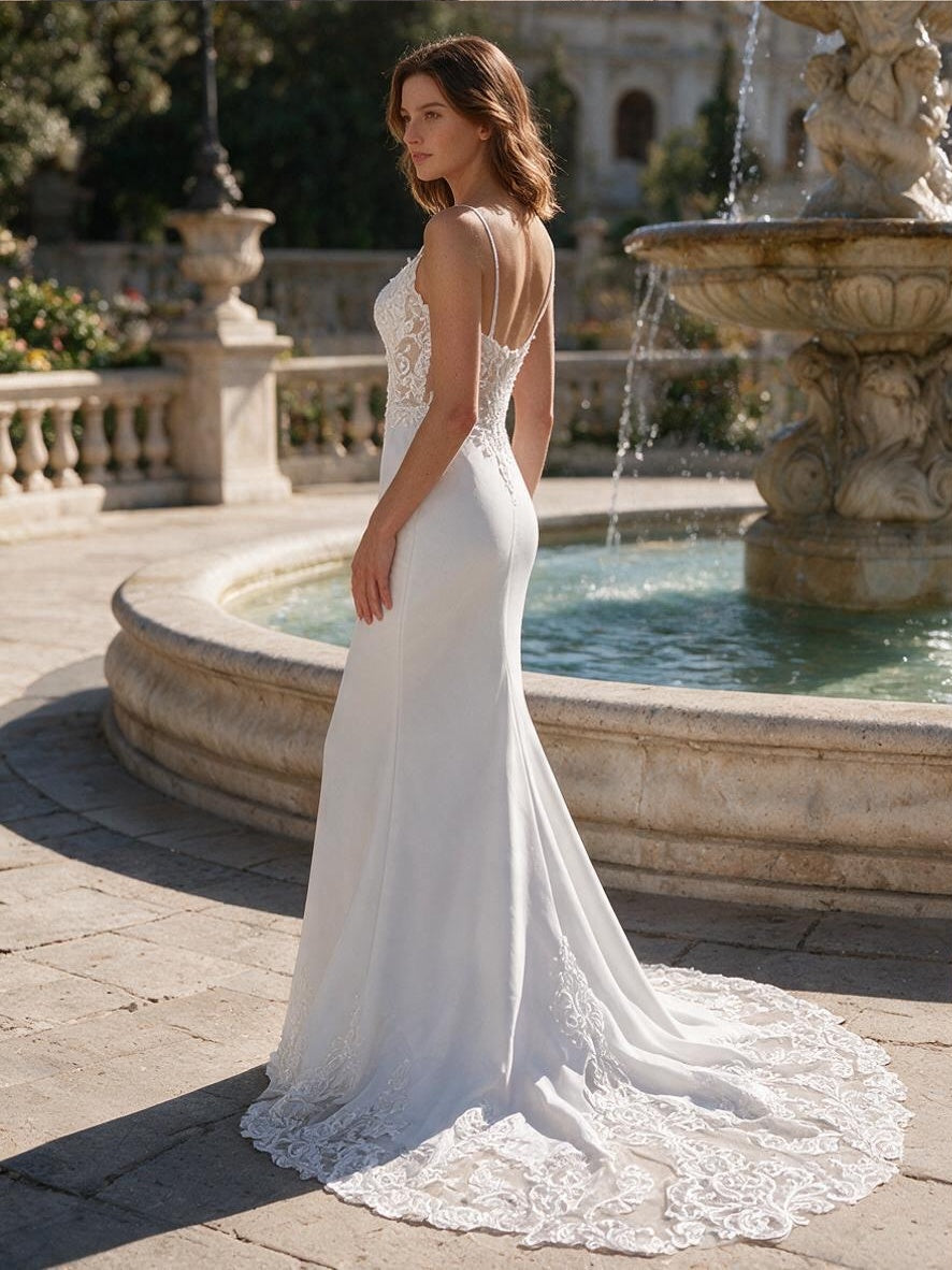 Lacey Bridal Ltd. Verena ivory mermaid wedding gown with sheer lace bodice, spaghetti straps, and lace cutout train.