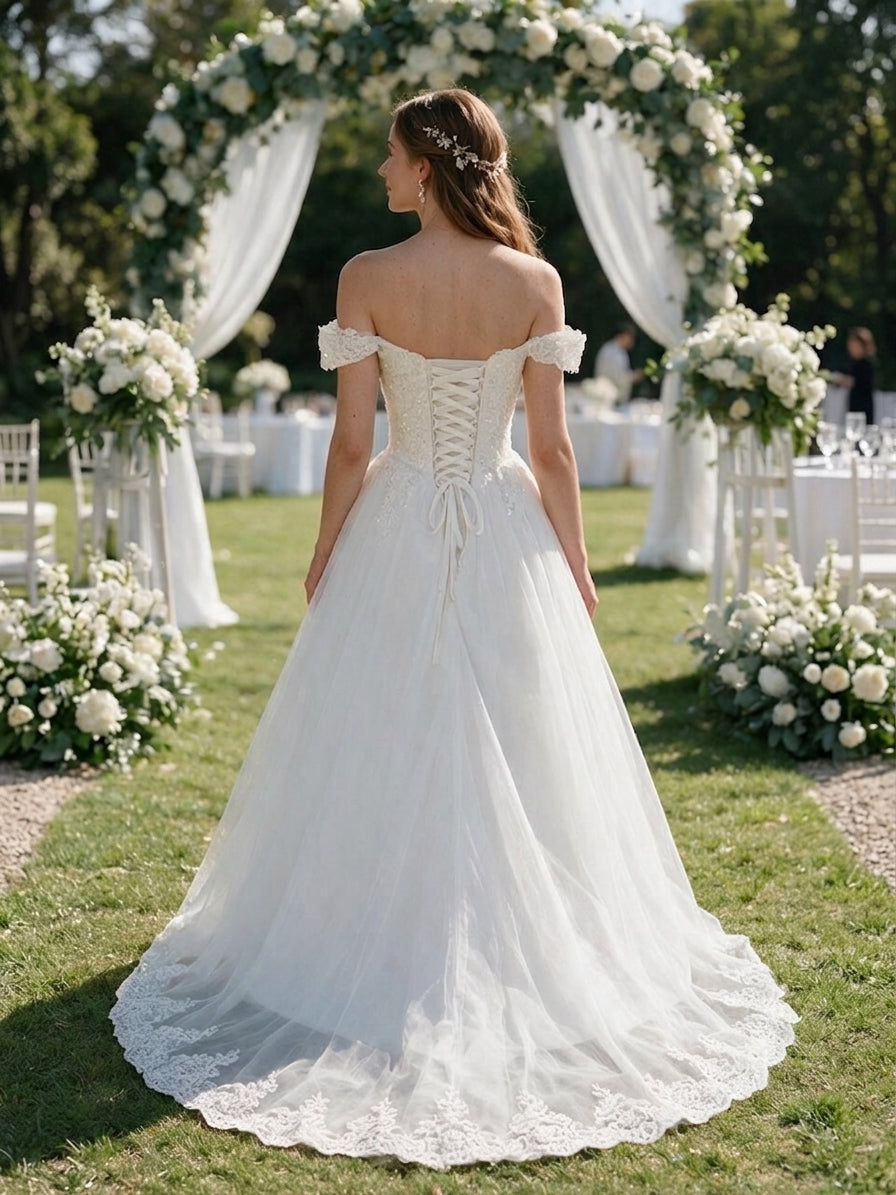 Lacey Bridal Ltd. Violetta A-line wedding gown with off-the-shoulder lace straps, corset back, and tulle skirt.