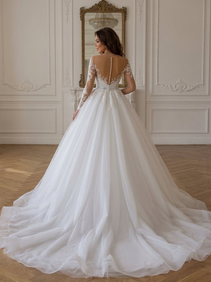 Lacey Bridal Ltd. Zelina ball gown with illusion V-back, long lace sleeves, and a full tulle skirt with a long train.