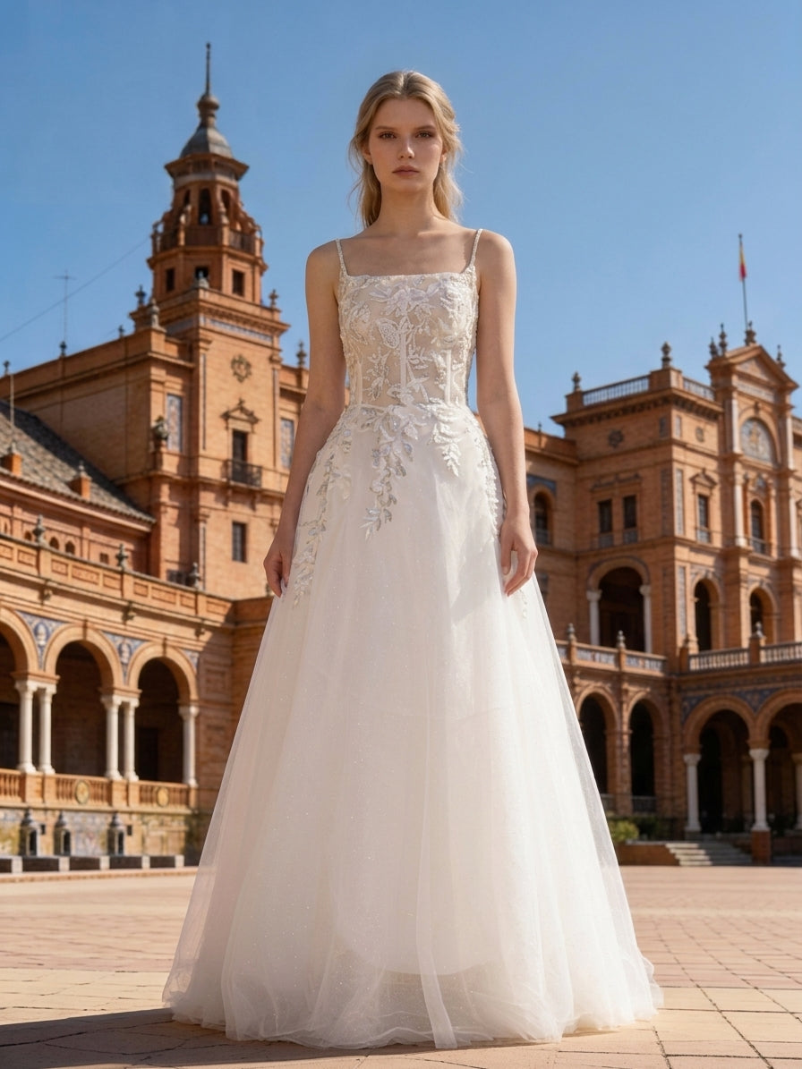 Lacey Bridal Ltd. ZOE A-line wedding gown with square neckline, beaded straps, and glitter tulle skirt in historic plaza