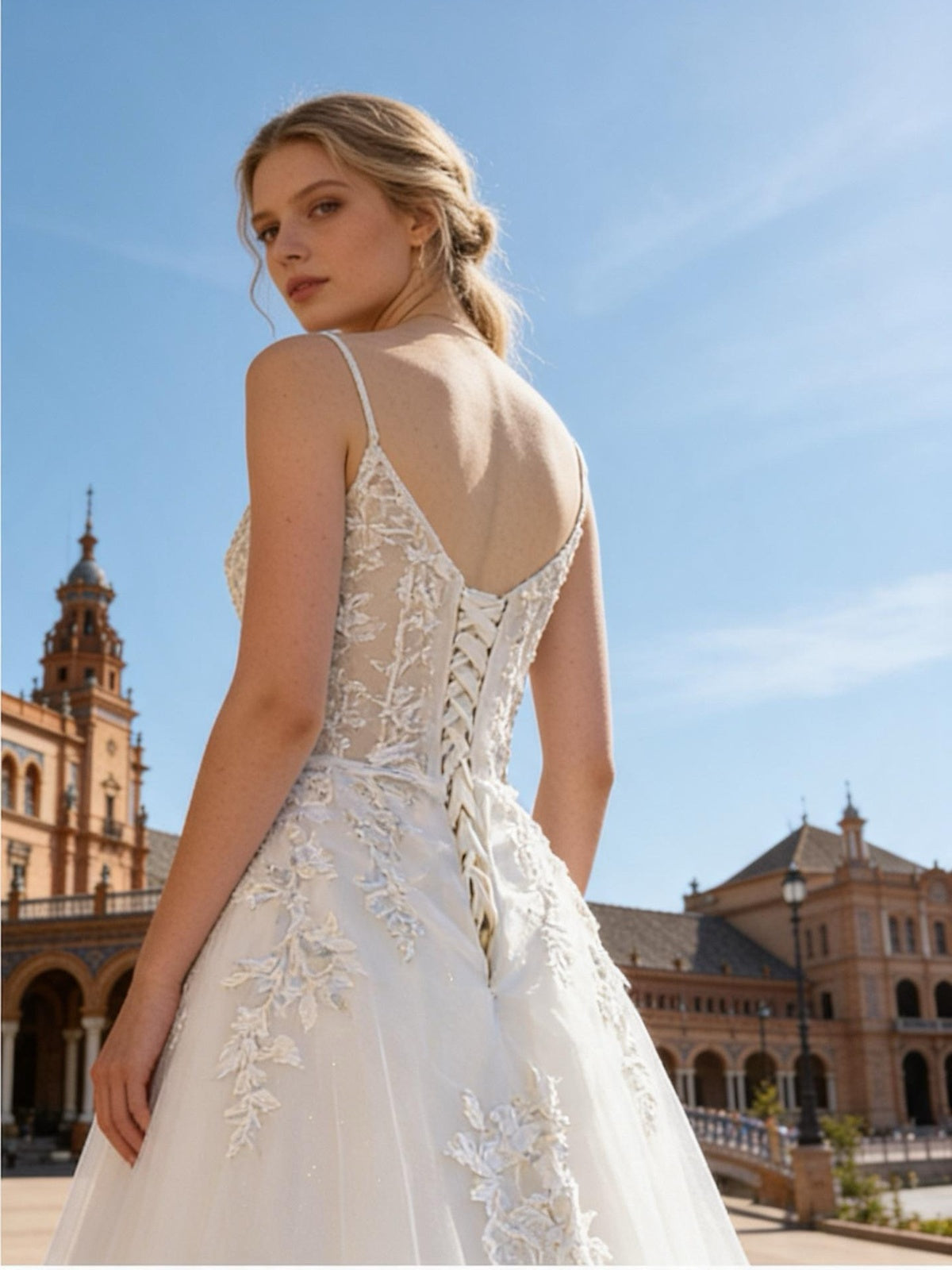 Lacey Bridal Ltd. Zoe A-line wedding gown with lace bodice, corset back, and glitter tulle skirt in an outdoor setting
